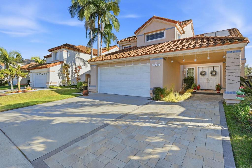 25252 Misty Ridge Mission Viejo, CA 92692 - Photo 3 of 42 a view of a white house with a yard and plants