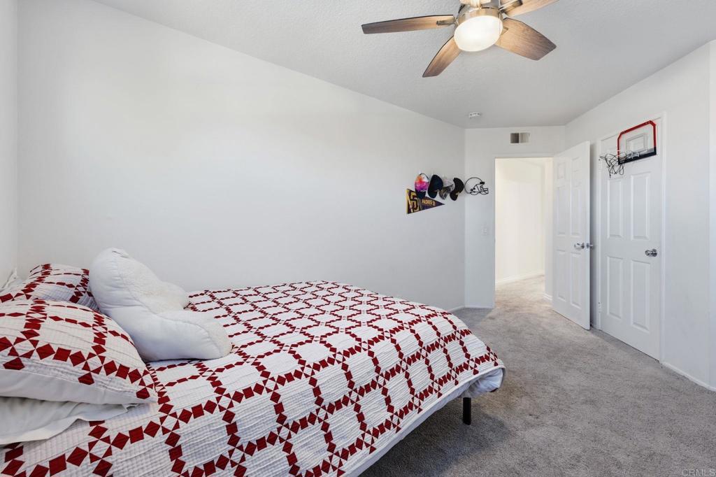 25252 Misty Ridge Mission Viejo, CA 92692 - Photo 36 of 42 a bedroom with a bed and a chandelier