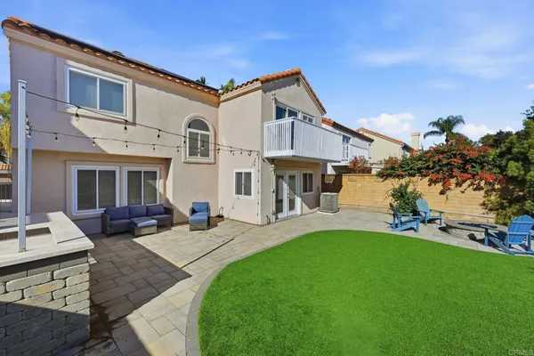 a view of a house with a yard and sitting area