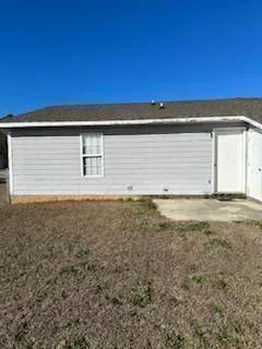 a view of a house with a backyard