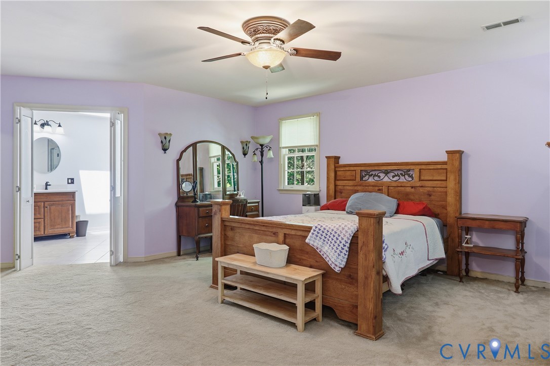 12512 2nd Branch Road Chesterfield, VA 23838 - Photo 27 of 56 a bedroom with a bed and a chandelier