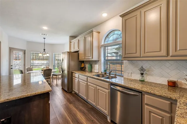 a kitchen with granite countertop lots of counter top space and stainless steel appliances