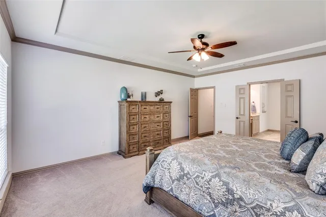a bedroom with a bed window and a chandelier