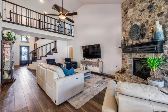 a living room with furniture a flat screen tv and a fireplace