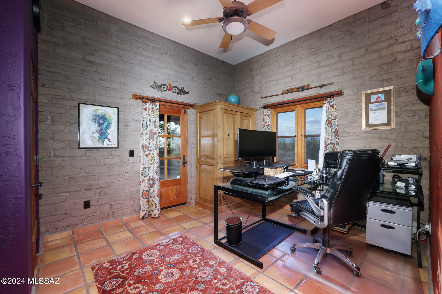 11725 East Spanish Ridge Place Tucson, AZ 85730 - Photo 29 of 51 a view of a workspace with furniture and a window