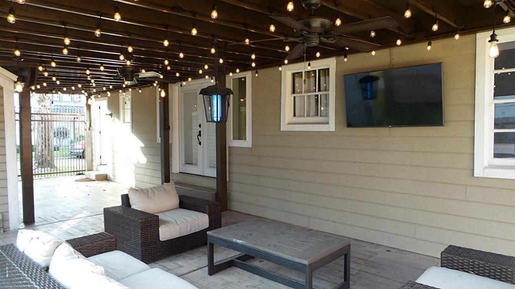 2611 Tangley Street Houston, TX 77005 - Photo 4 of 31 Enjoy seamless outdoor entertaining in a fully gated, expansive backyard.