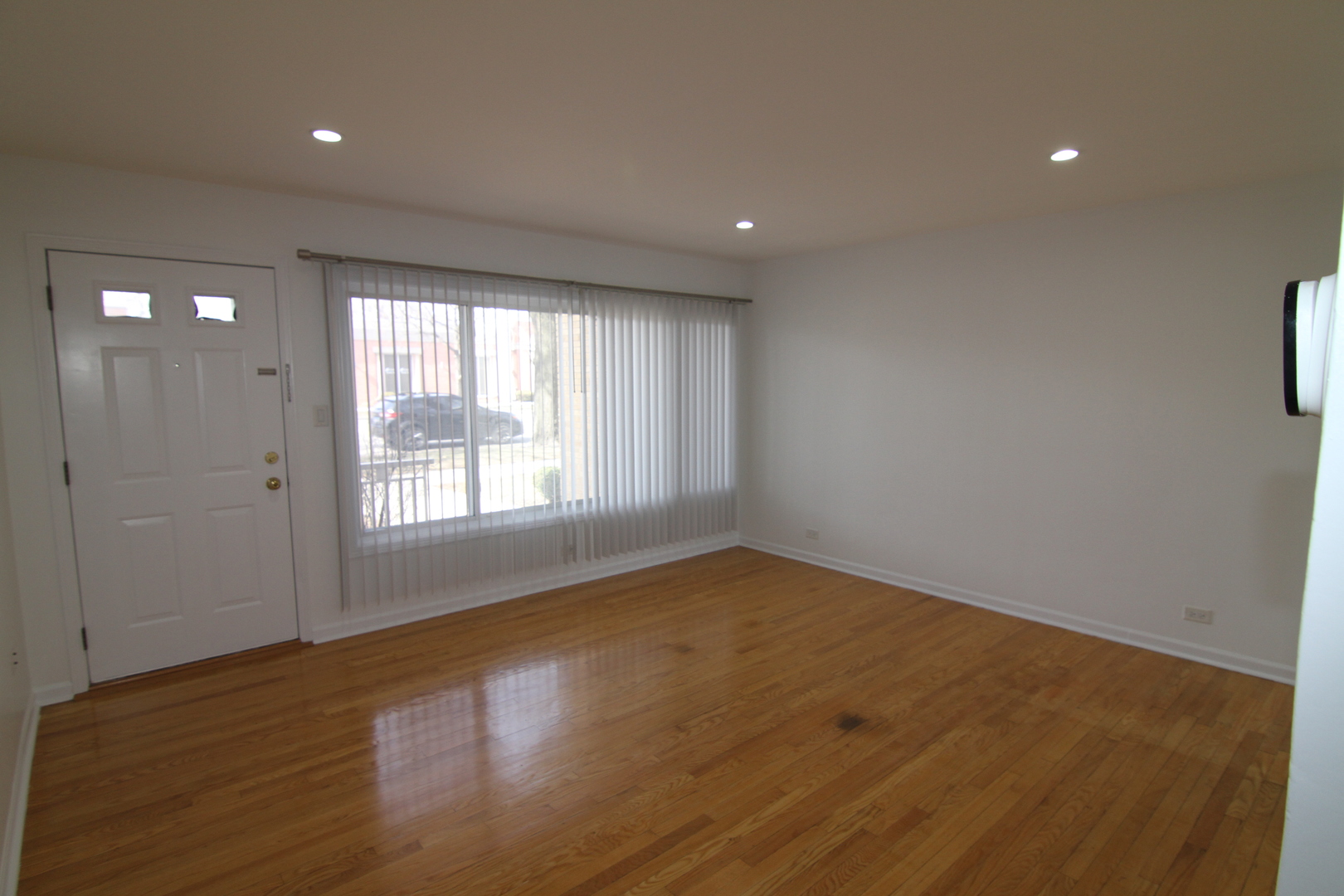 4909 North Harlem Avenue, Unit 1 Chicago, IL 60656 - Photo 2 of 8 an empty room with wooden floor and windows