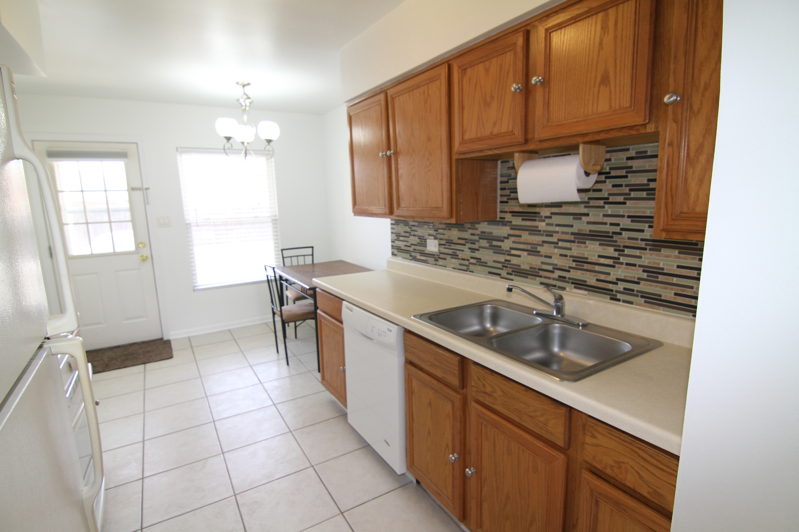 4909 North Harlem Avenue, Unit 1 Chicago, IL 60656 - Photo 5 of 8 a kitchen with a sink cabinets and window