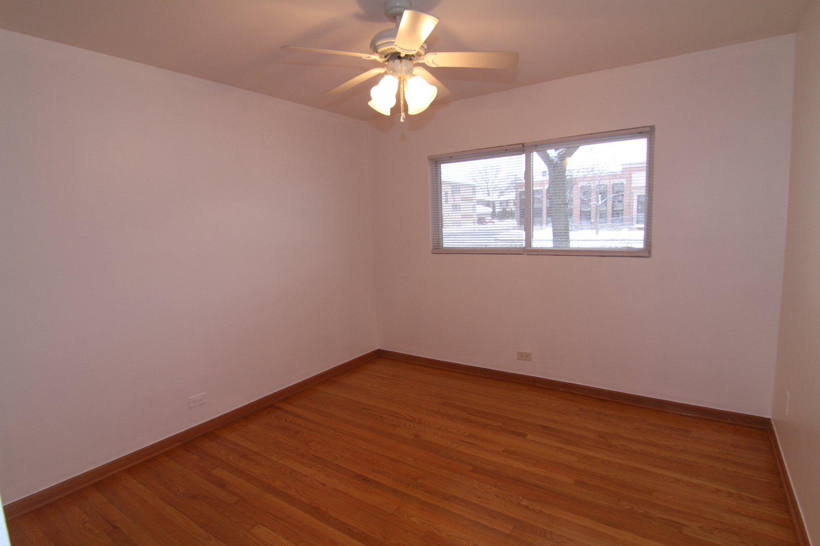 4909 North Harlem Avenue, Unit 1 Chicago, IL 60656 - Photo 7 of 8 an empty room with a window and a fan