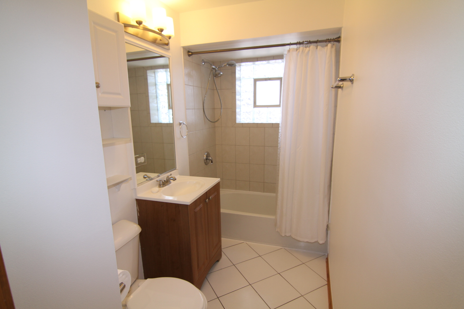 4909 North Harlem Avenue, Unit 1 Chicago, IL 60656 - Photo 8 of 8 a bathroom with a sink a toilet and mirror