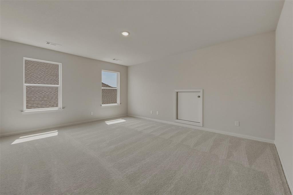 1337 Frio Drive Springtown, TX 76082 - Photo 18 of 40 Neutral-toned wall paint, recessed ceiling lighting, light-colored carpeting, two windows, and a wall access panel