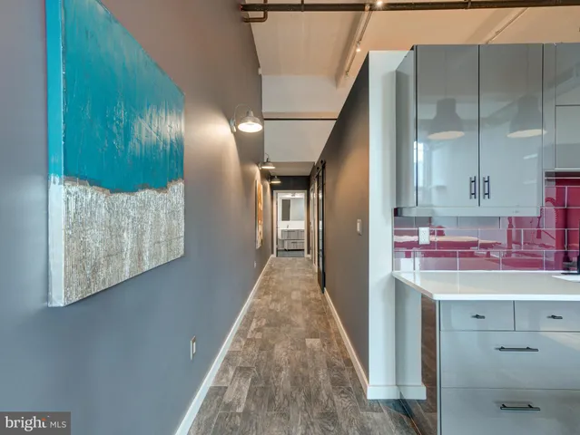 a view of hallway with seating and kitchen view