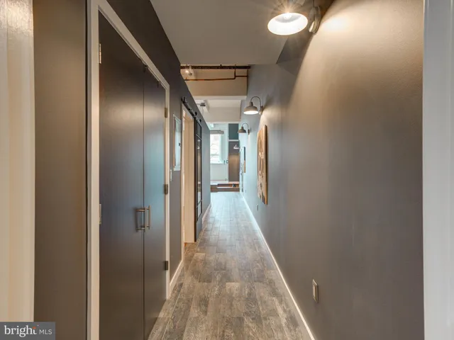 a view of hallway with wooden floor
