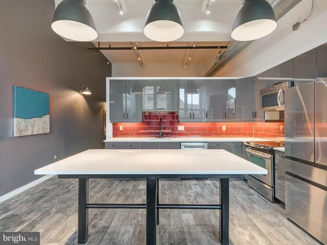 a kitchen with a table chairs and chandelier