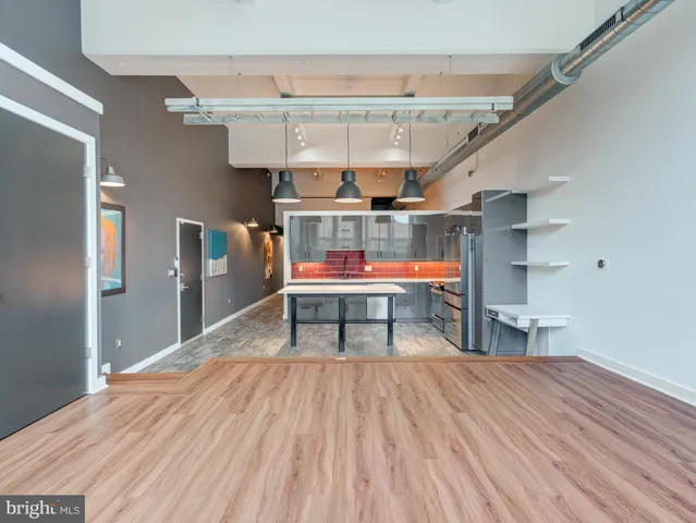 a room with wooden floor and furniture