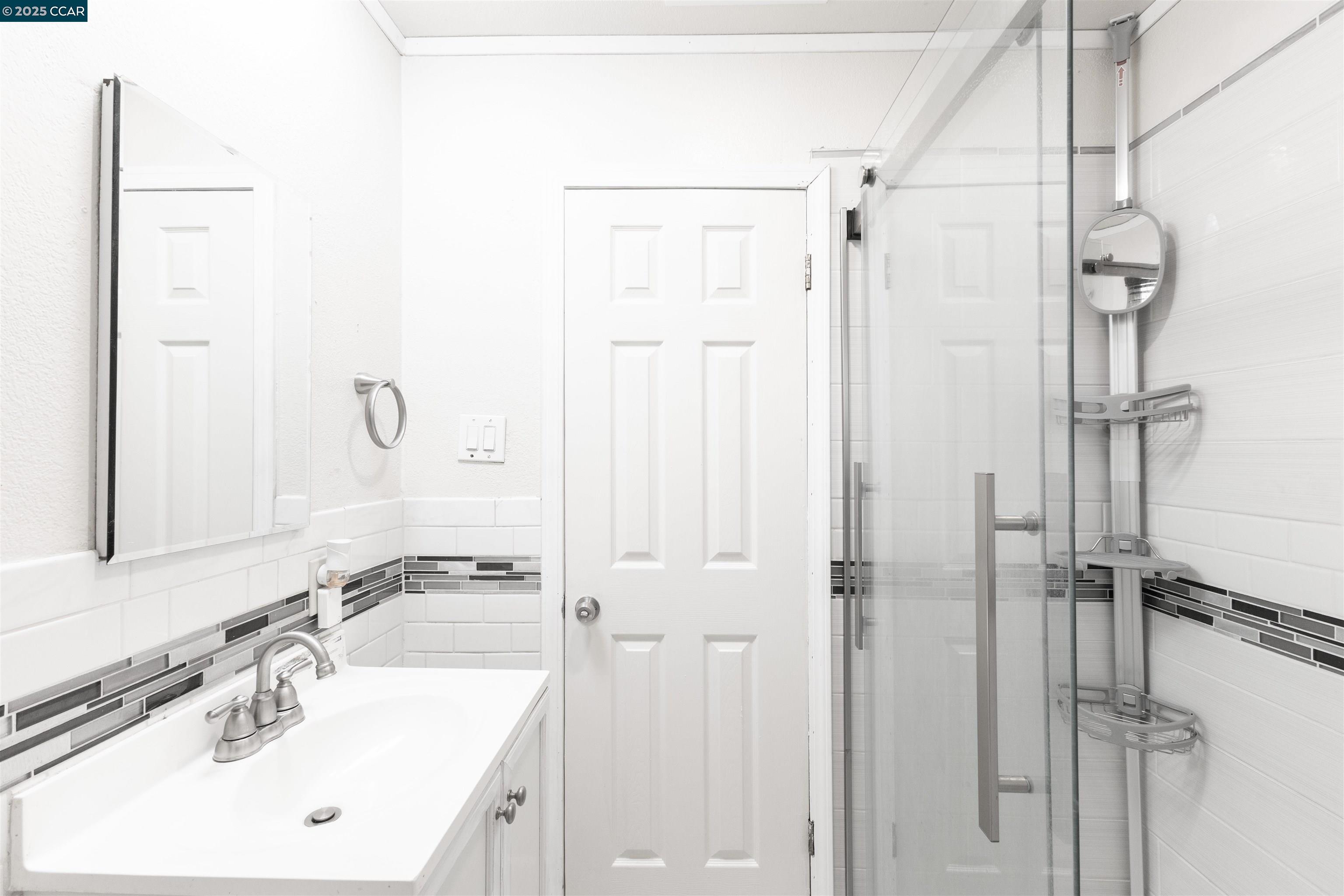 2106 Goff Avenue Pittsburg, CA 94565 - Photo 18 of 27 a bathroom with a sink a mirror and a shower