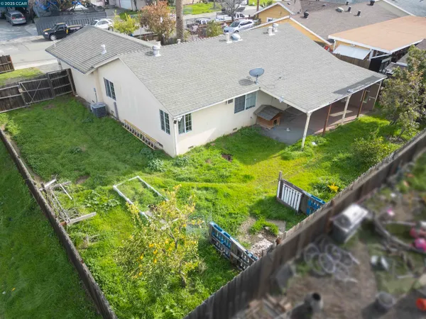 an aerial view of residential houses with yard