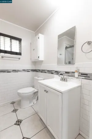 a bathroom with a sink a toilet and mirror
