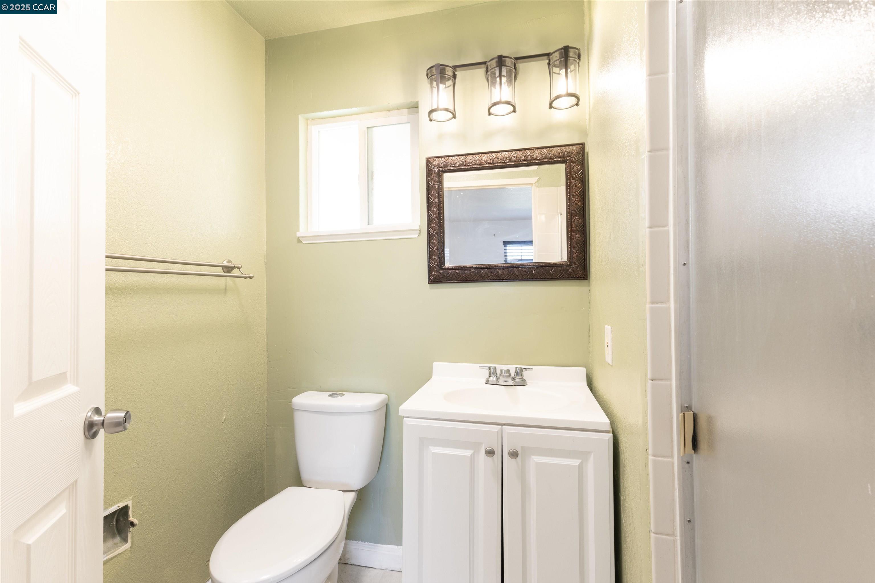 2106 Goff Avenue Pittsburg, CA 94565 - Photo 24 of 27 a bathroom with a toilet sink and mirror