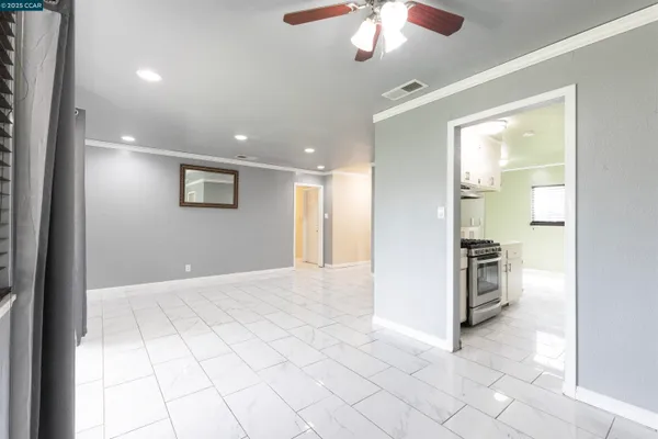 a kitchen with stainless steel appliances a stove a sink and a refrigerator