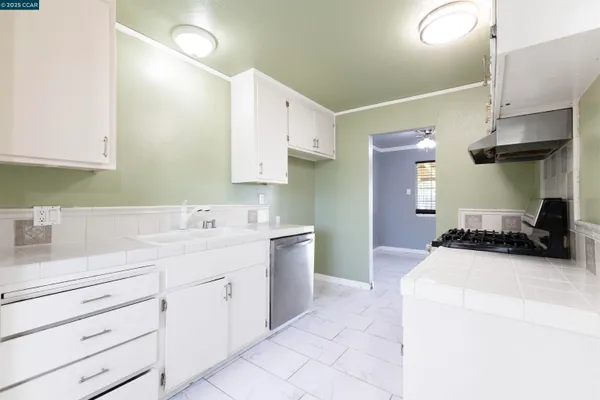 a large white kitchen with white cabinets