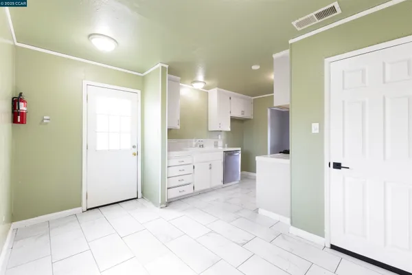 a kitchen with cabinets and stainless steel appliances