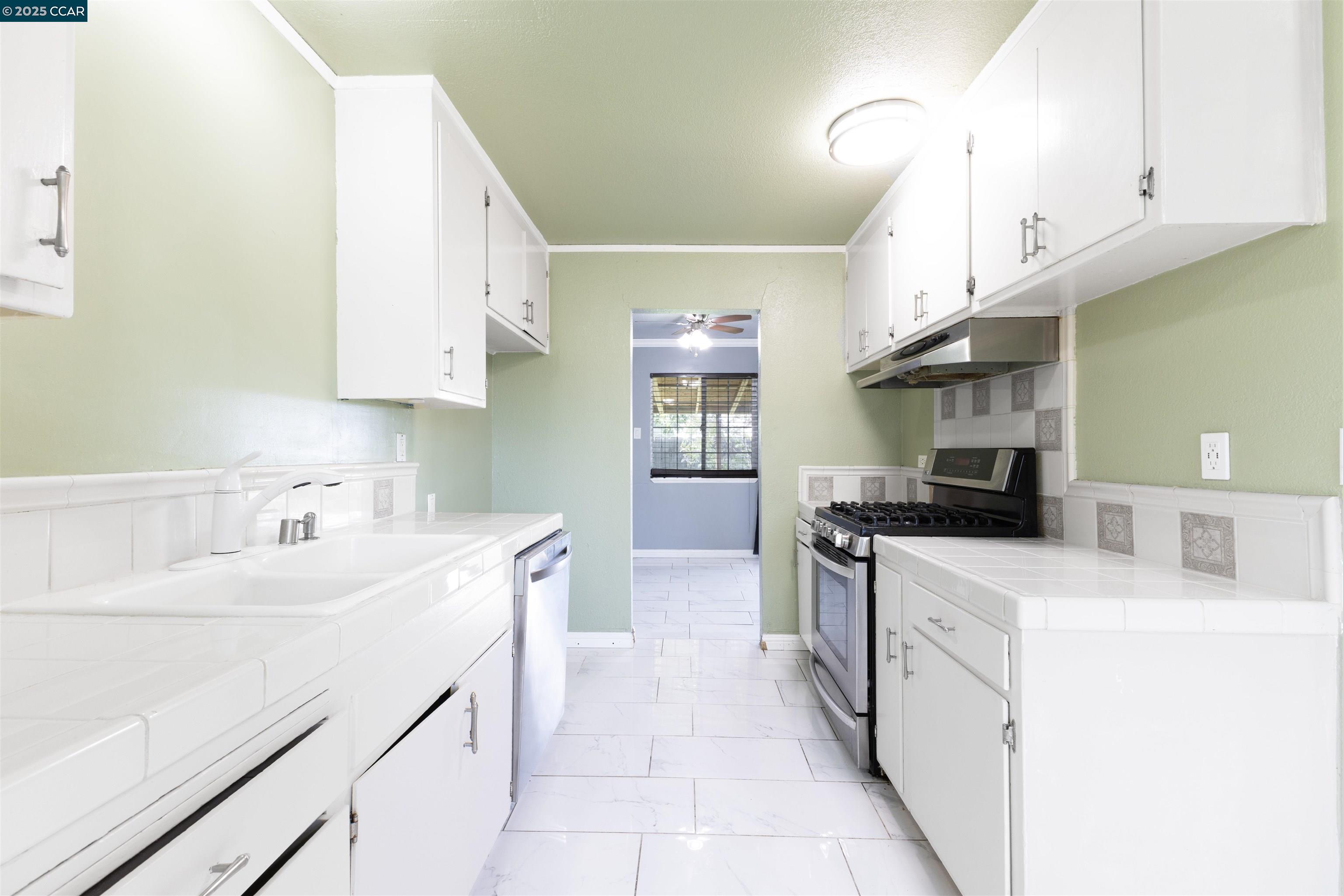 2106 Goff Avenue Pittsburg, CA 94565 - Photo 10 of 27 a kitchen with stainless steel appliances a sink a stove and a refrigerator