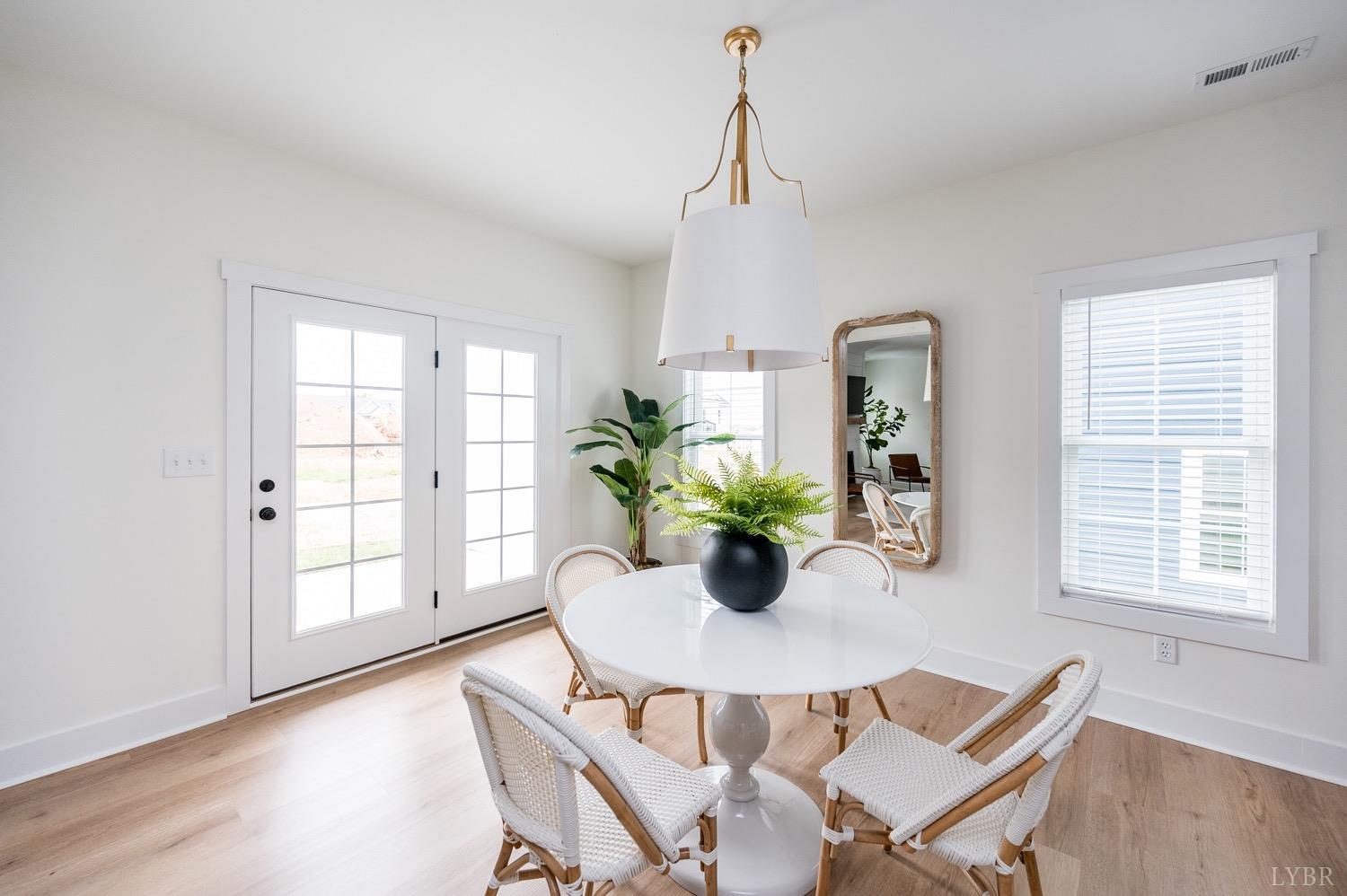 574 Leesville Road Lynchburg, VA 24502 - Photo 12 of 54 a view of a dining room with furniture and a potted plant