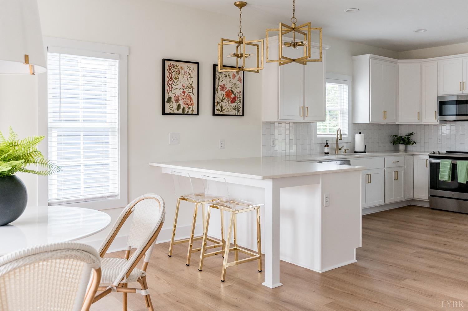 574 Leesville Road Lynchburg, VA 24502 - Photo 13 of 54 a kitchen with a table chairs sink and cabinets