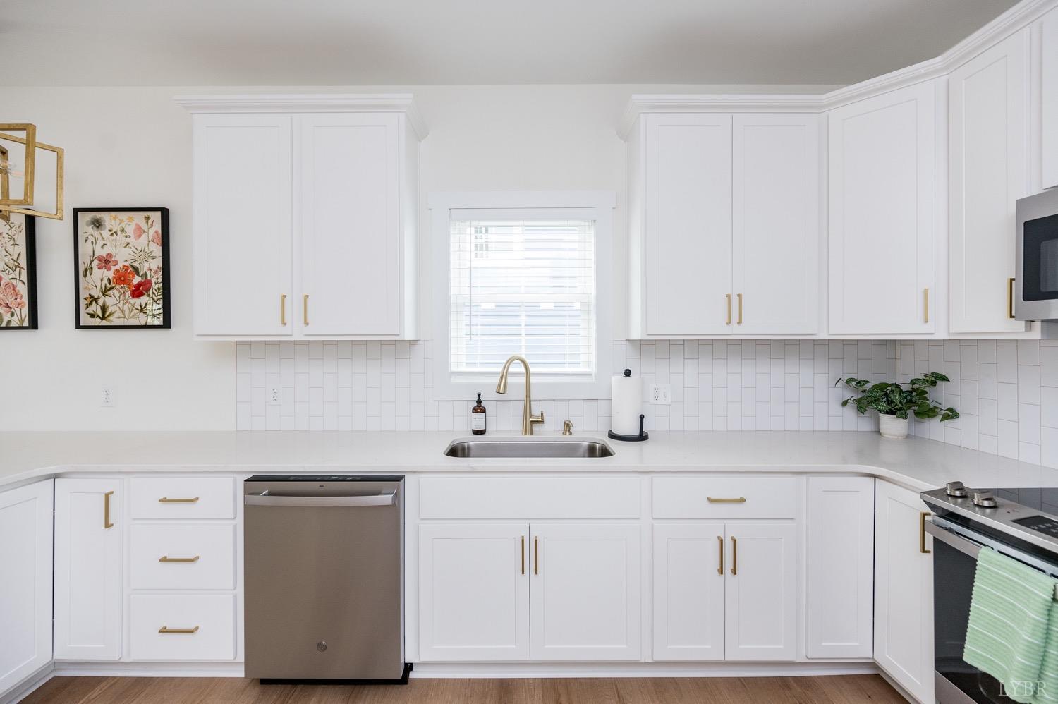 574 Leesville Road Lynchburg, VA 24502 - Photo 15 of 54 a kitchen with white cabinets and white appliances
