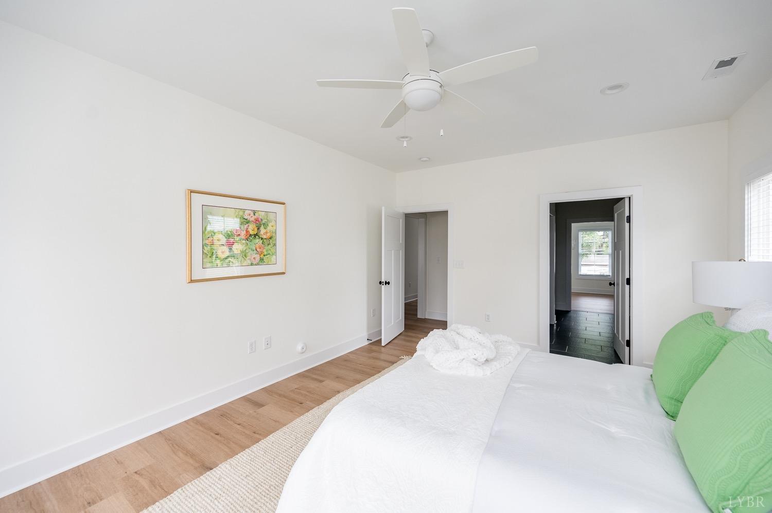 574 Leesville Road Lynchburg, VA 24502 - Photo 25 of 54 a bedroom with a bed and a chandelier