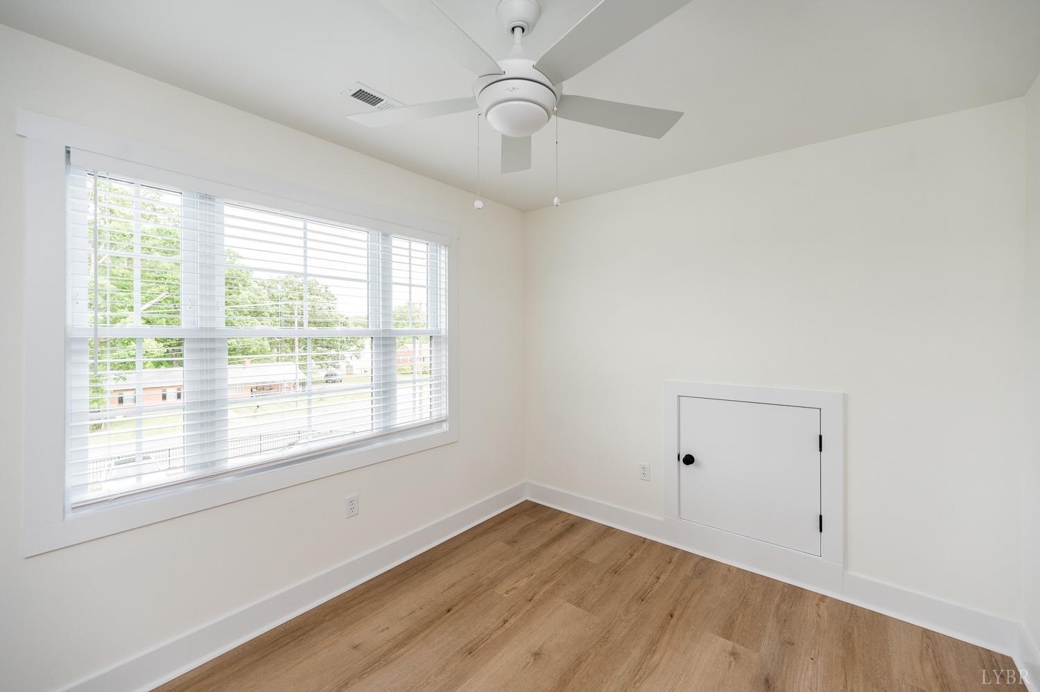 574 Leesville Road Lynchburg, VA 24502 - Photo 43 of 54 a view of an empty room with wooden floor and a window