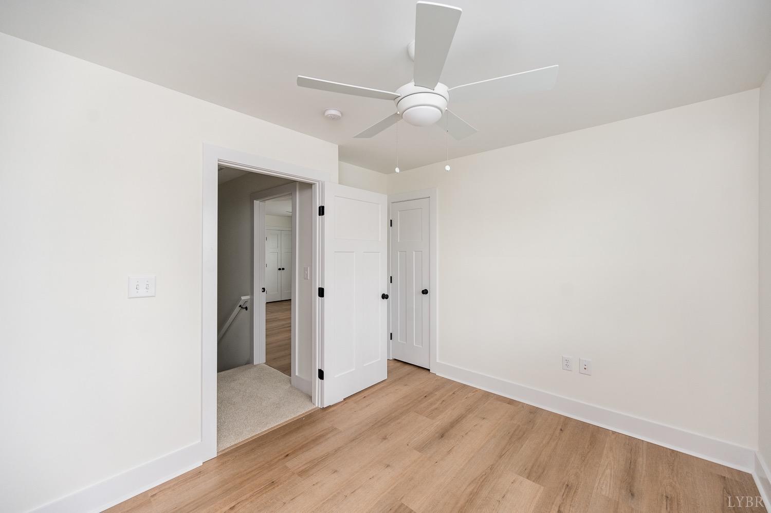 574 Leesville Road Lynchburg, VA 24502 - Photo 44 of 54 an empty room with wooden floor and fan
