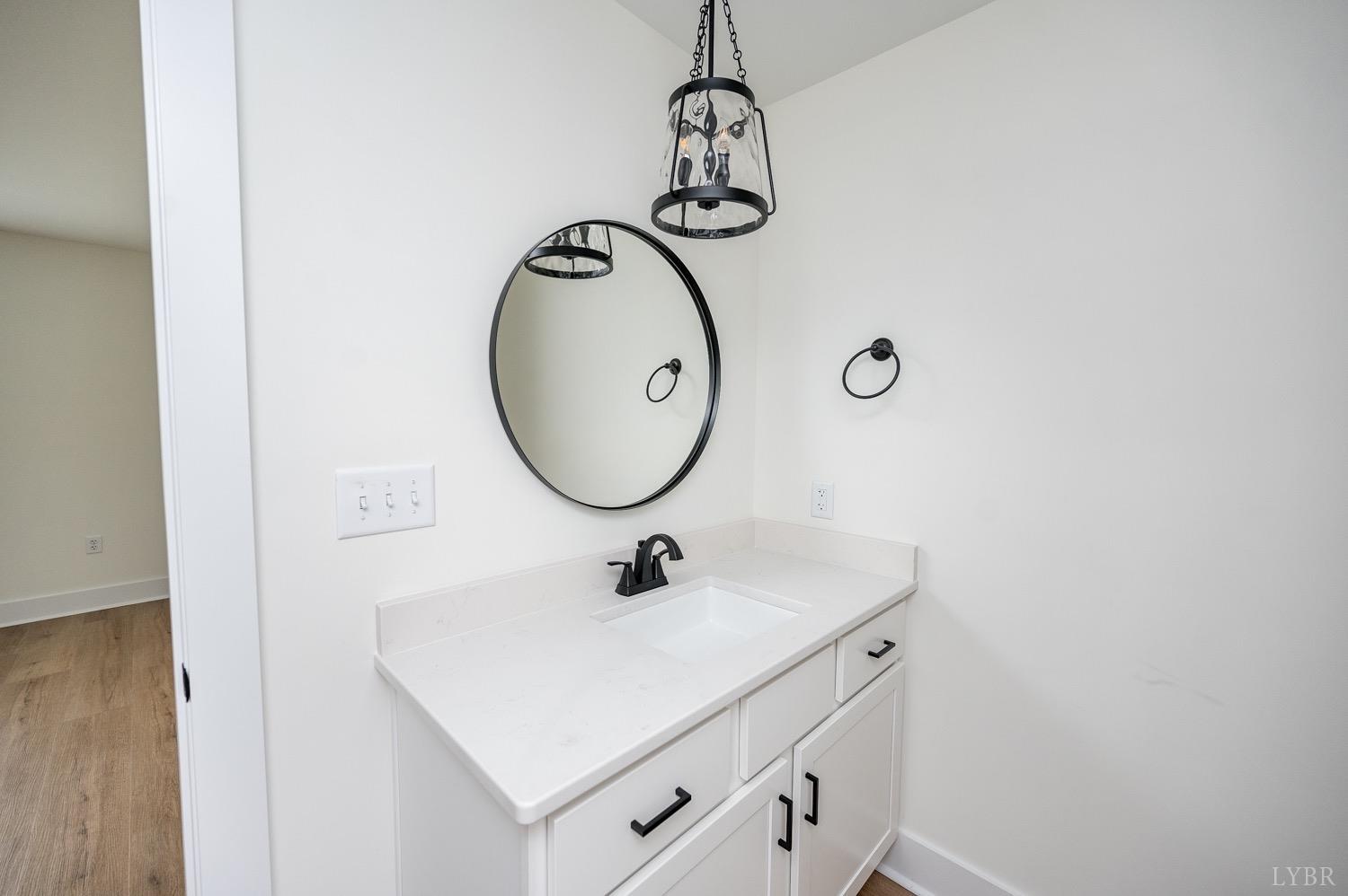 574 Leesville Road Lynchburg, VA 24502 - Photo 49 of 54 a bathroom with a sink a mirror and a light fixture