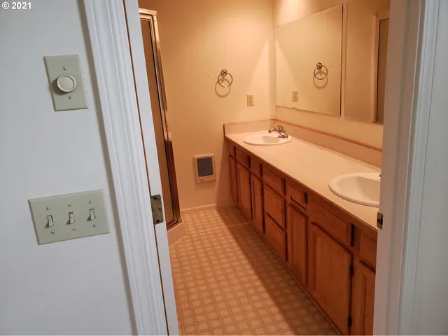 a bathroom with a sink a mirror and a shower