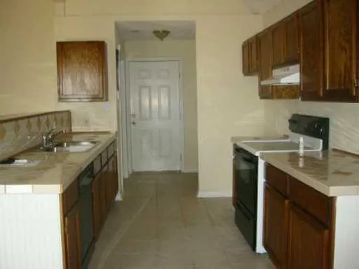 a kitchen with stainless steel appliances granite countertop a sink stove and cabinets