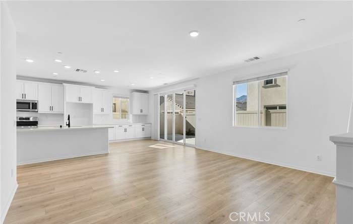 24119 Ashton Corona, CA 92883 - Photo 22 of 45 a view of large kitchen with wooden floor and windows