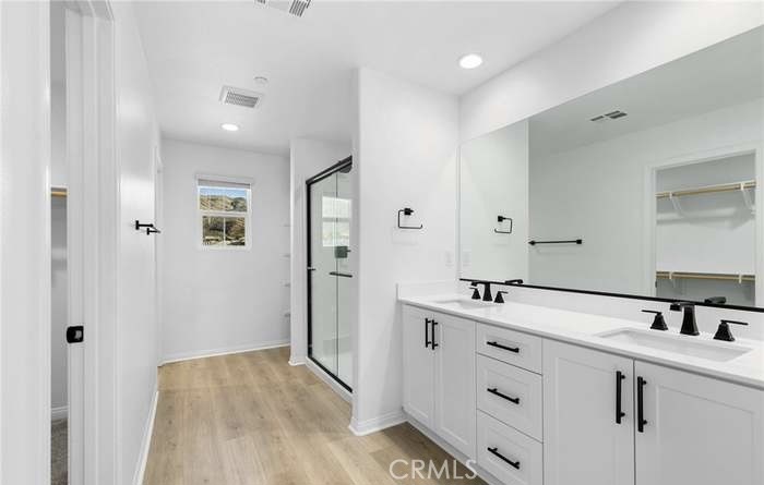 24119 Ashton Corona, CA 92883 - Photo 28 of 45 a bathroom with a sink and mirror