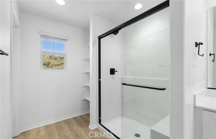 24119 Ashton Corona, CA 92883 - Photo 32 of 45 a bathroom with a glass shower door