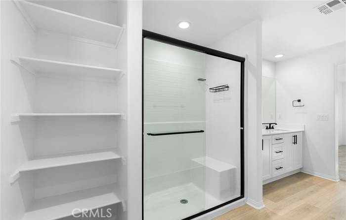 24119 Ashton Corona, CA 92883 - Photo 36 of 45 a bathroom with a glass shower door