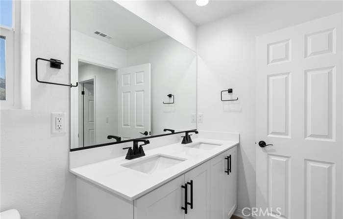 24119 Ashton Corona, CA 92883 - Photo 42 of 45 a bathroom with a sink and a mirror