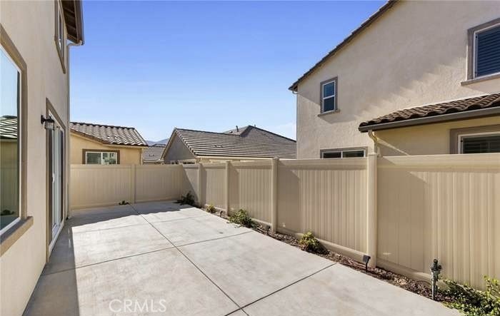 24119 Ashton Corona, CA 92883 - Photo 6 of 45 a view of a house with a wooden fence