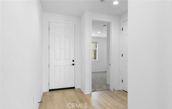 24119 Ashton Corona, CA 92883 - Photo 9 of 45 a view of room with walk in closet and wooden floor