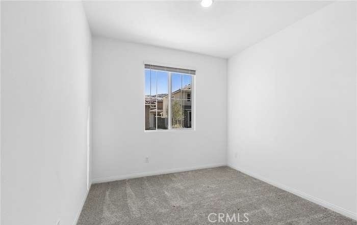 24119 Ashton Corona, CA 92883 - Photo 10 of 45 a view of an empty room with a window