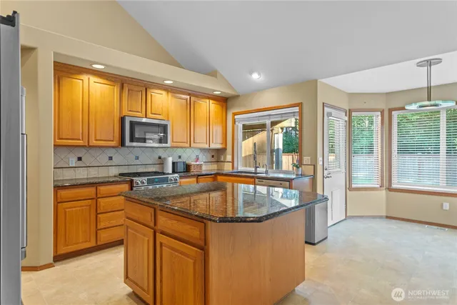 a bedroom with furniture a fireplace and a large window