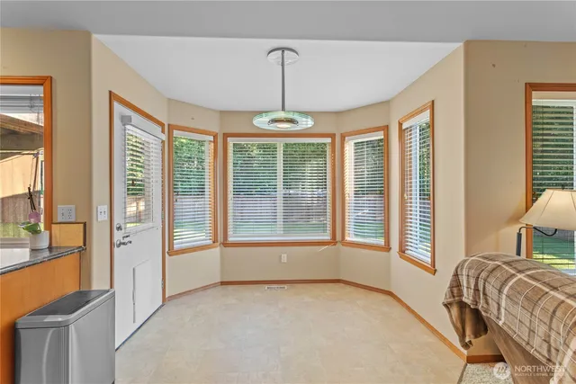 a bedroom with a bed and a flat tv screen on dresser
