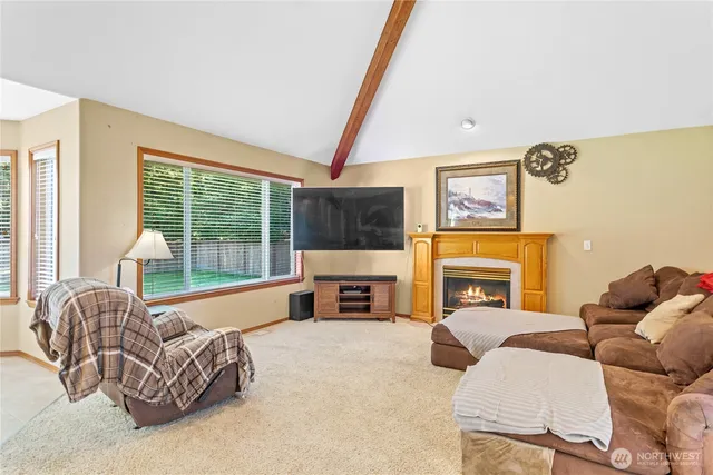 a bedroom with a bed and a flat tv screen on dresser