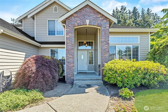 a front view of a house with garden