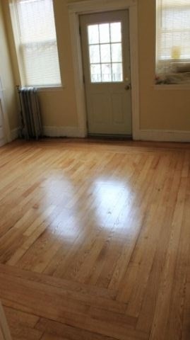 16 Copenger Street, Unit 2 Boston, MA 02120 - Photo 11 of 11 an empty room with wooden floor and windows