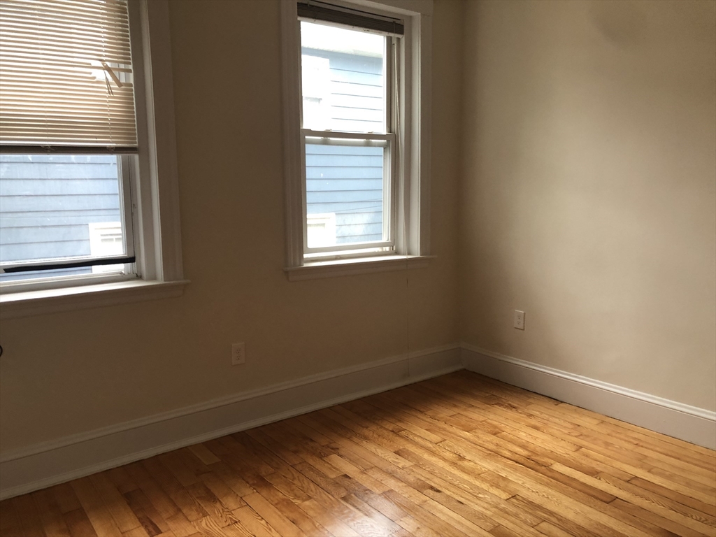 16 Copenger Street, Unit 2 Boston, MA 02120 - Photo 4 of 11 a view of a room with wooden floor and a window